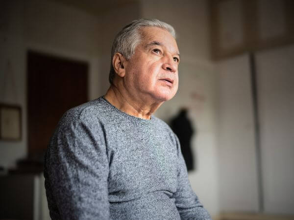 Image of man in kitchen with text overlayed saying 3.4 million households in Australia are food insecure