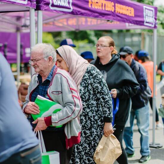 People in line getting foods in Foodbank event