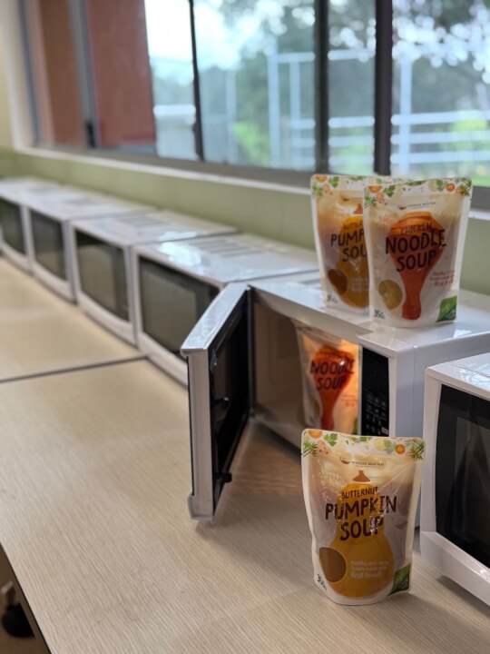 a microwave ovens on a counter with packet soup